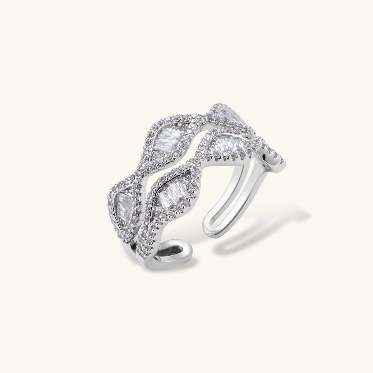 Layered adjustable ring with flowing wave design featuring baguette and round cubic zirconia stones in white gold plating