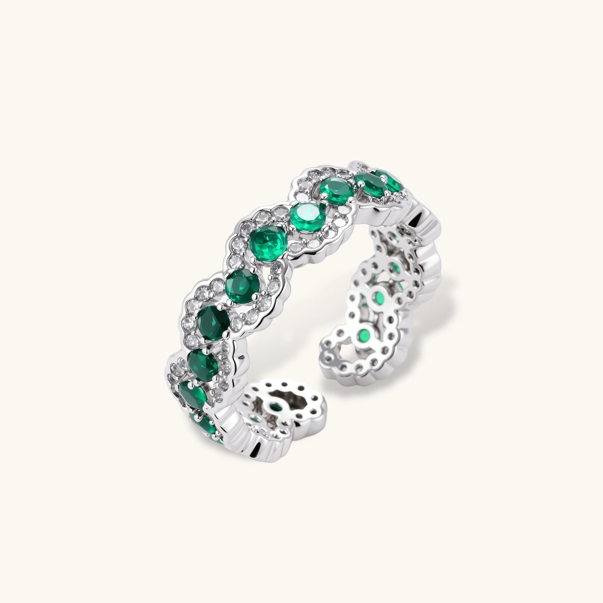 Open-back adjustable ring with round green zirconia stones and white zirconia scalloped edges in white gold plated eco-brass.