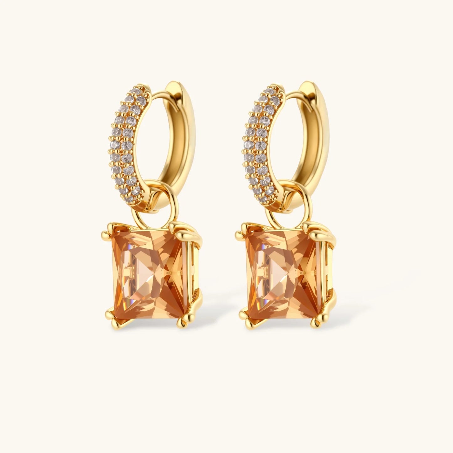 14K gold plated jewelry set featuring square champagne CZ stones with sparkling huggie earrings on cream background.