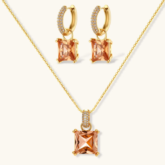 14K gold plated jewelry set featuring square champagne CZ stones with sparkling huggie earrings on cream background.