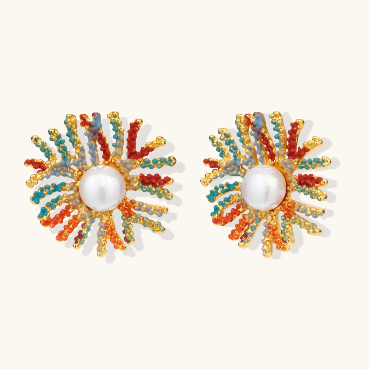 Vibrant starburst stud earrings with multicolor enamel rays and white pearl centers on gold-plated setting
