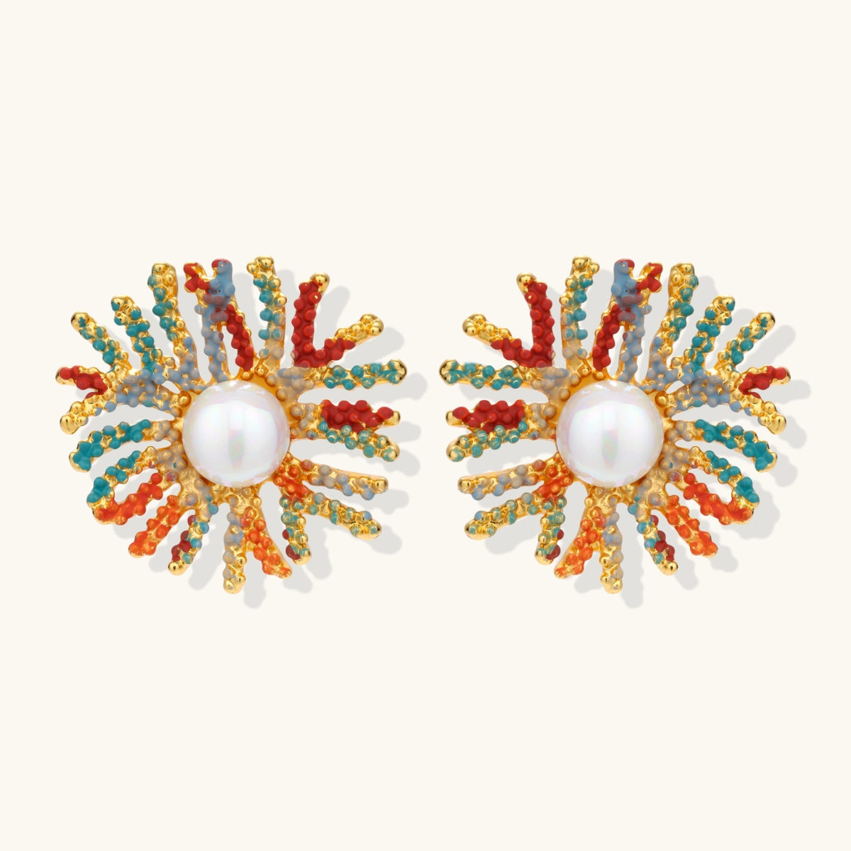 Vibrant starburst stud earrings with multicolor enamel rays and white pearl centers on gold-plated setting