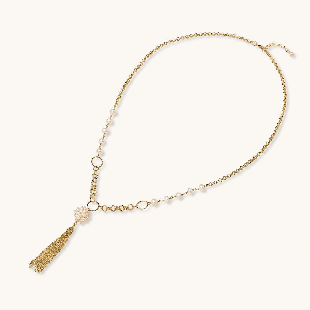 Long gold-plated necklace with freshwater pearls, chunky chain links, and flowing tassel pendant