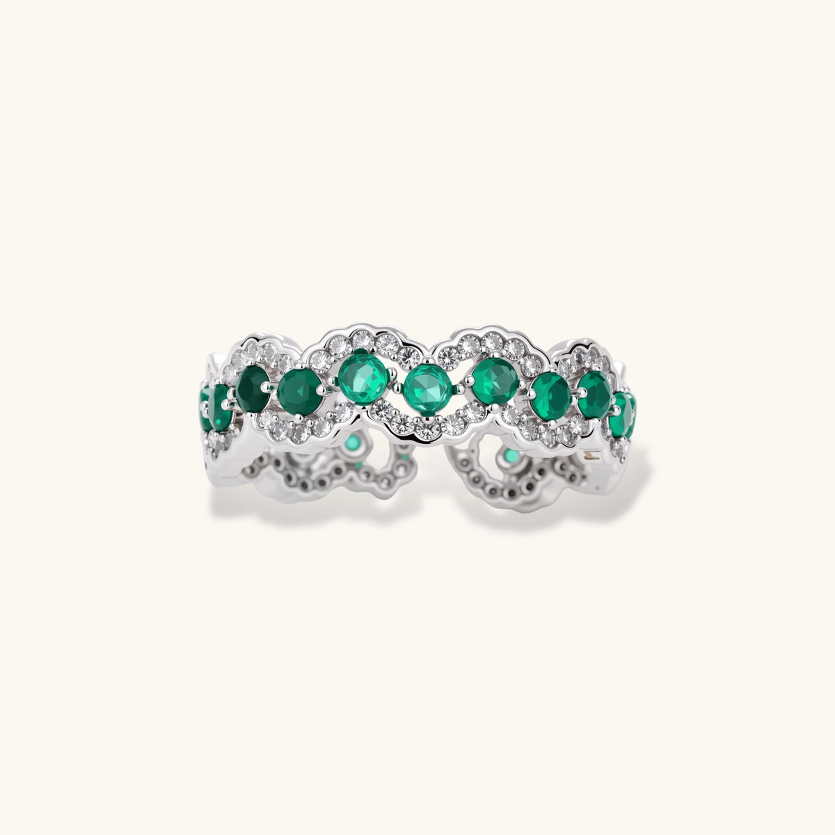 Open-back adjustable ring with round green zirconia stones and white zirconia scalloped edges in white gold plated eco-brass.